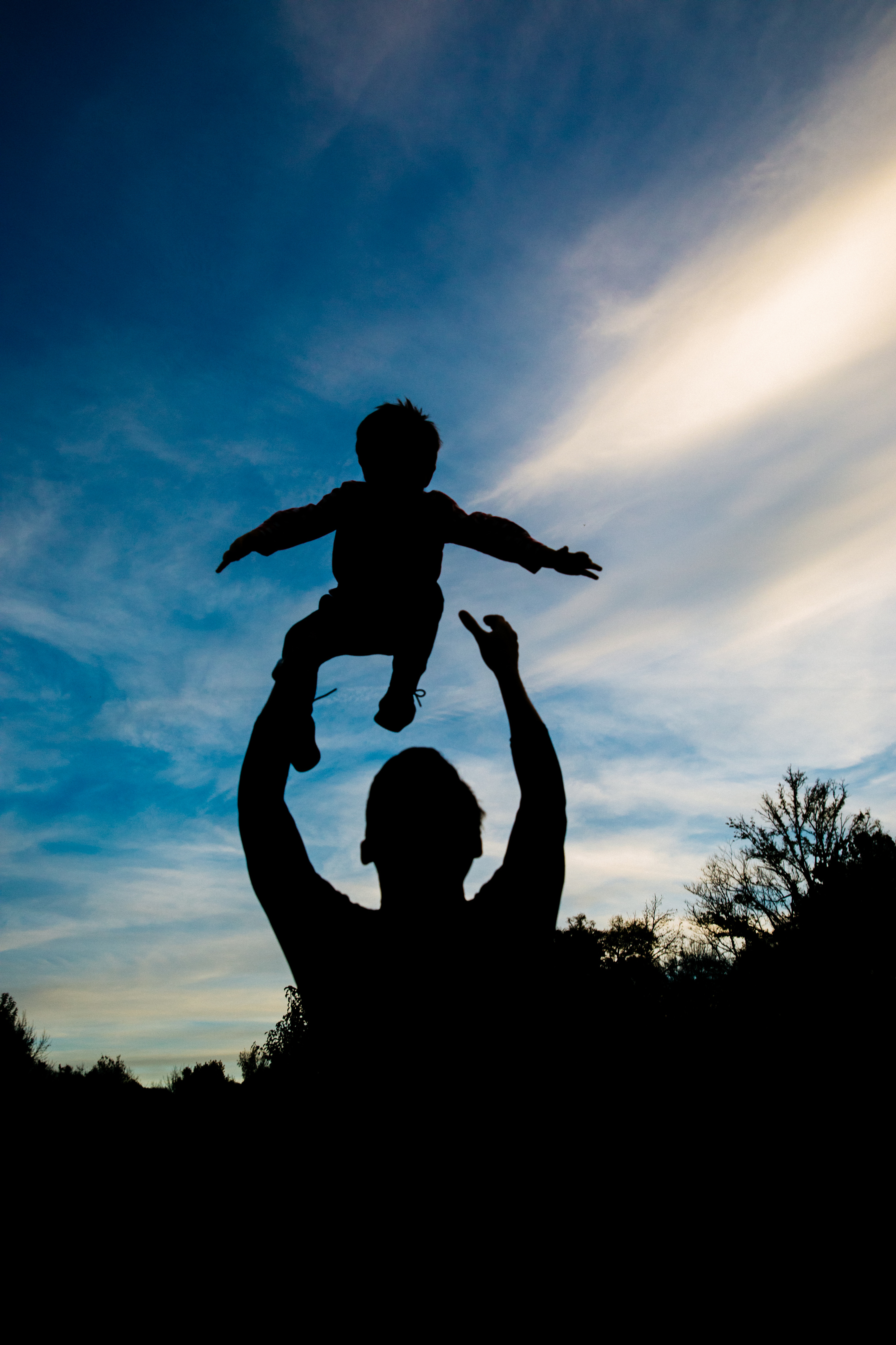 Silhouette of Man Throwing Baby
